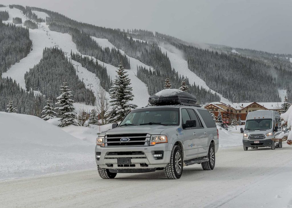 Summit Express Vans Winter in front of ski area